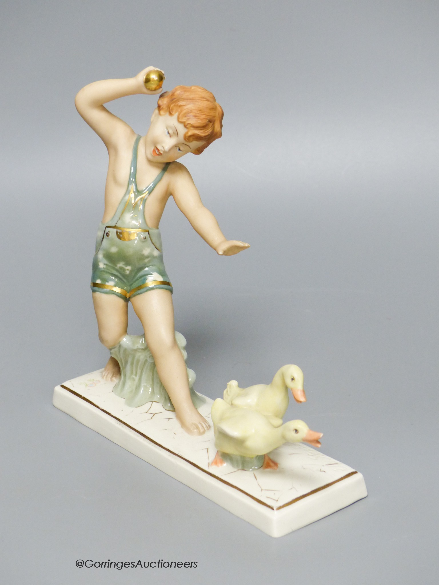 A Royal Dux group of a boy with ducks, 18cm tall